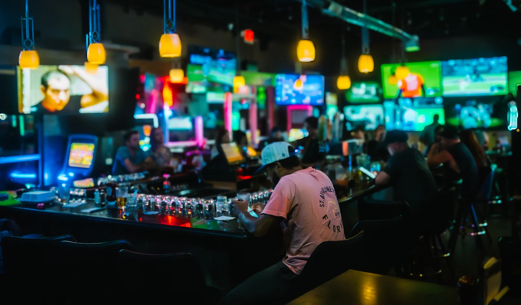 The bar, screens, and neon at Jerzes